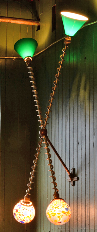 A wall piece employing found objects and hand blown glass by Harry Anderson